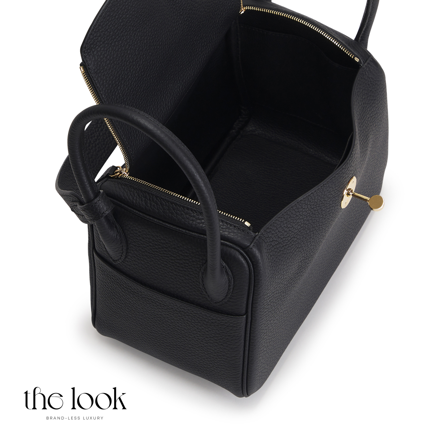 Black leather handbag with gold accents on a white background | The Look Officiel