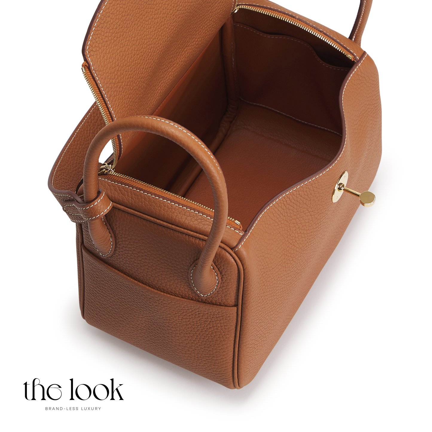 Brown leather handbag with gold accents on a white background | The Look Officiel