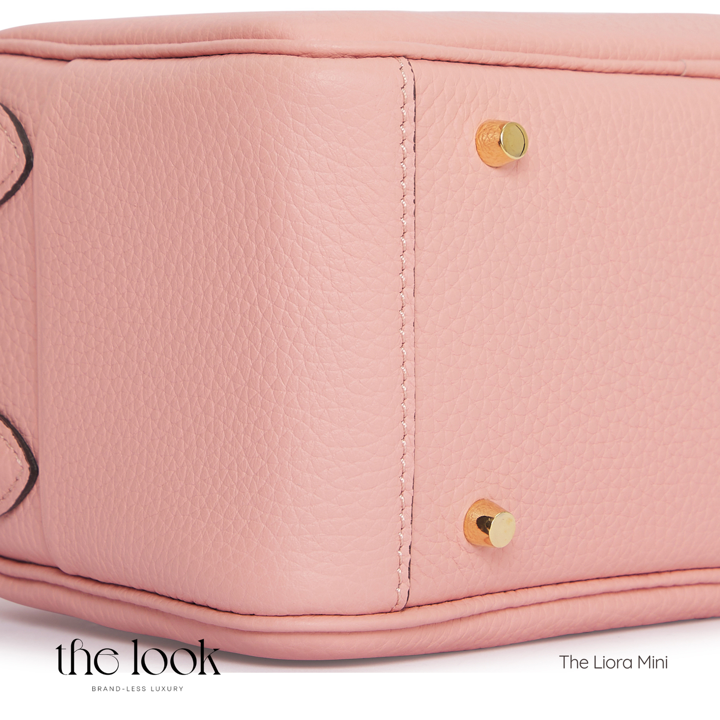 Close-up of a pink handbag with gold accents, featuring 'The Look' branding. | The Look Officiel