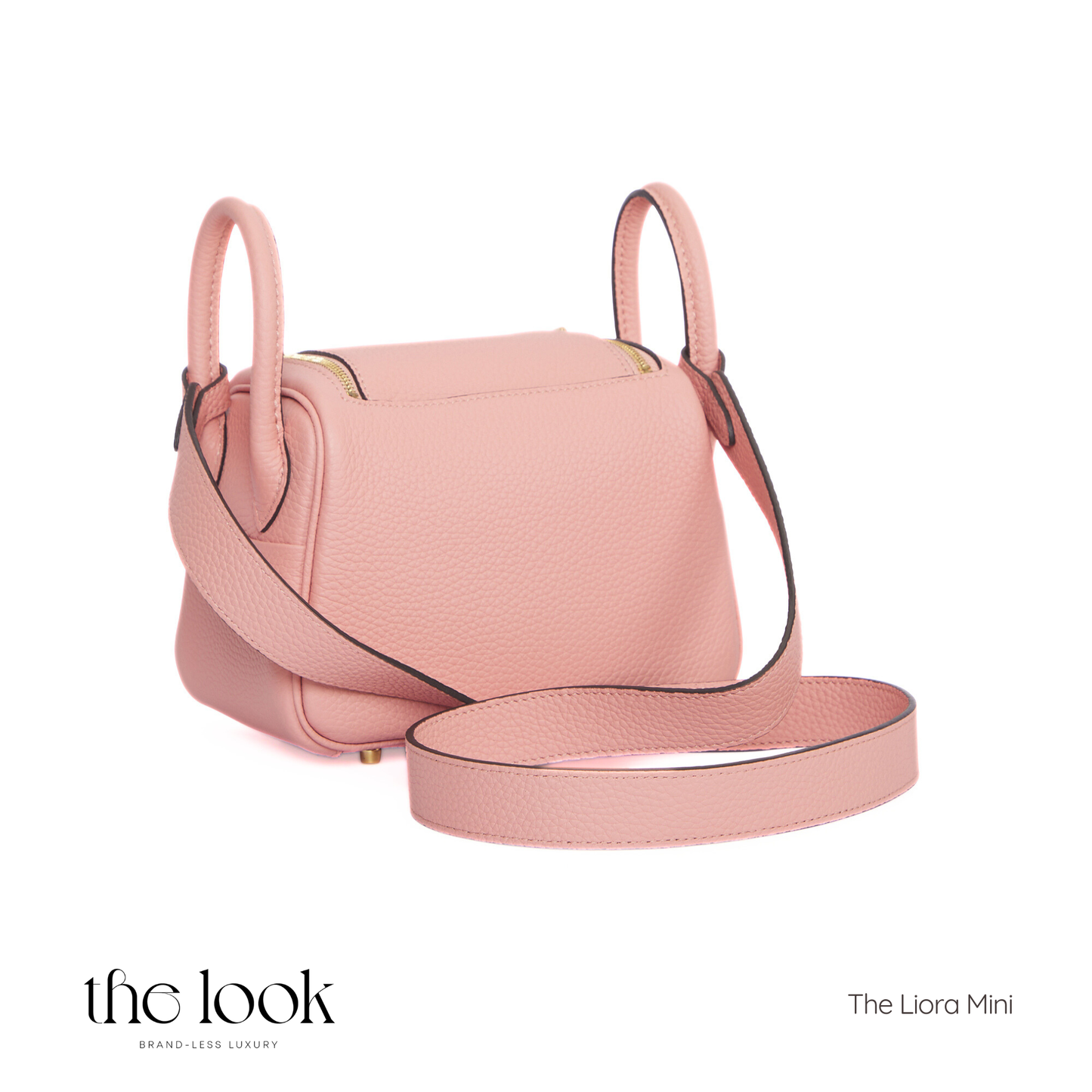 Pink handbag with a strap on a white background, featuring 'the look' branding. | The Look Officiel