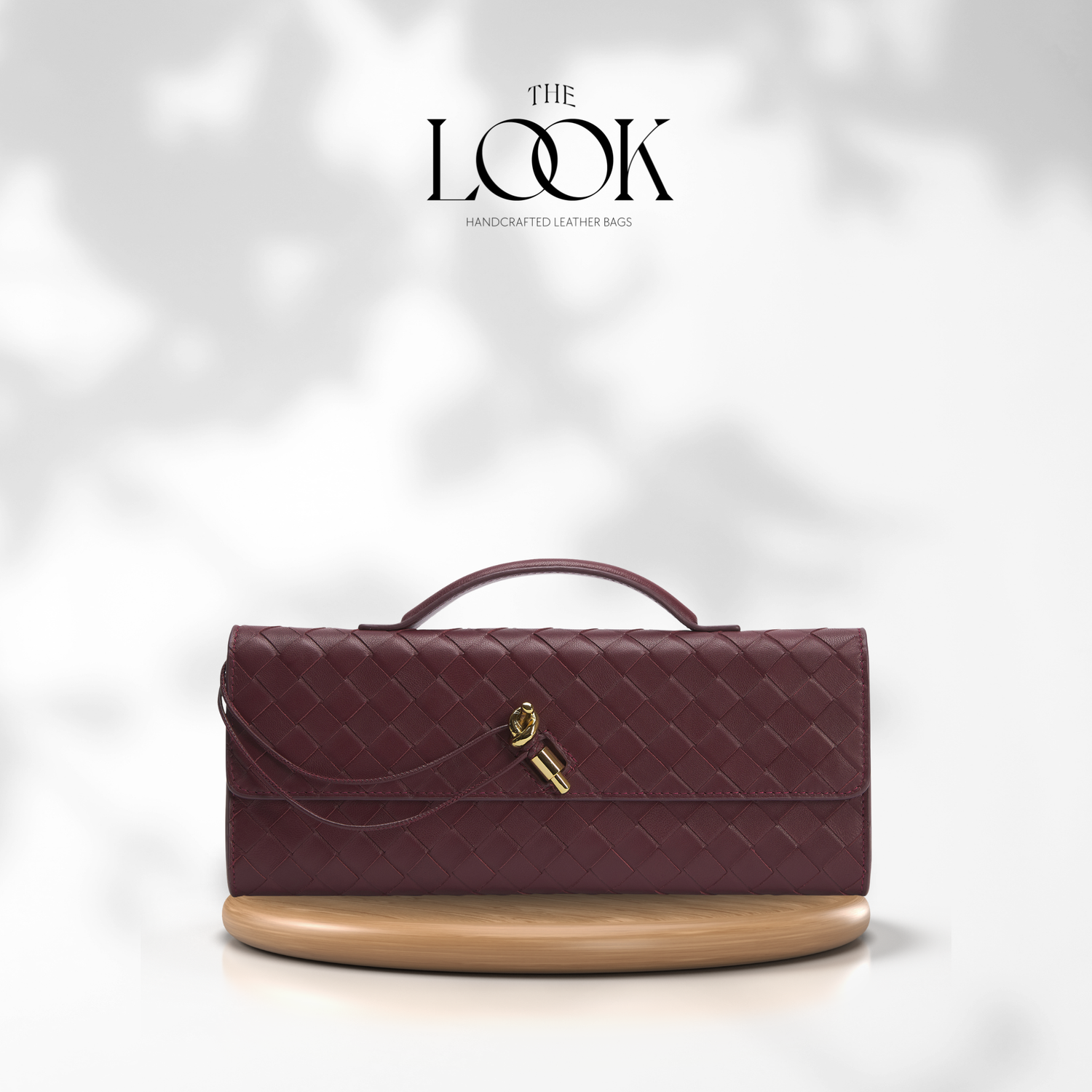 Maroon handbag with beige base on a white background, featuring 'The Look' brand. | The Look Officiel