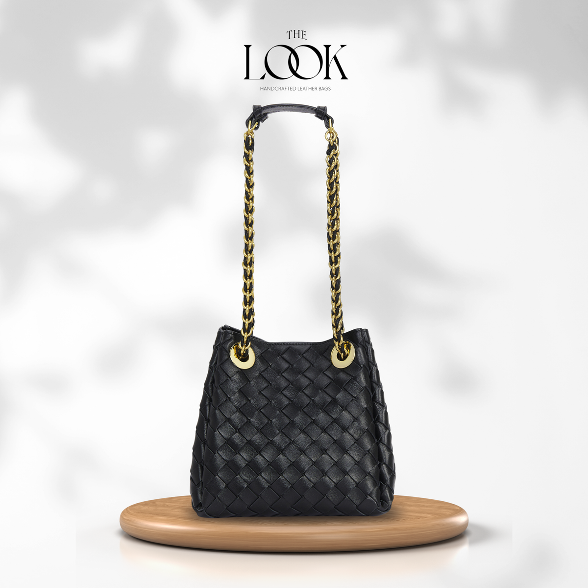 The Loop Small Chain Parachute Convertible Crossbody in black woven lambskin leather with gold-toned chain strap, front view | The Look Officiel