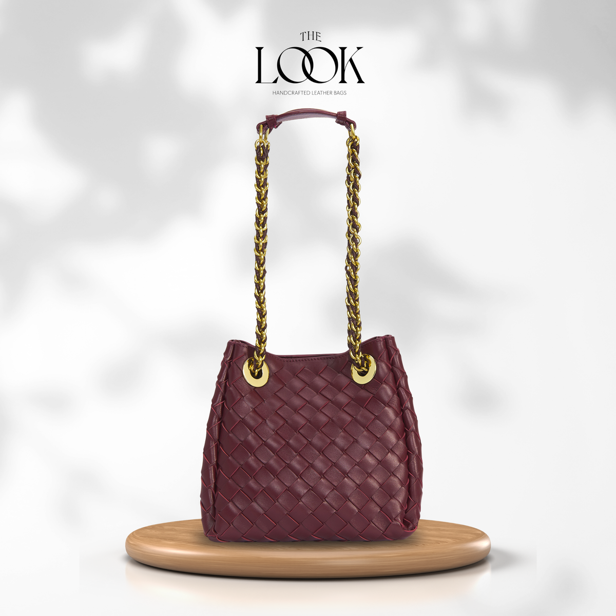 The Loop Small Chain Parachute Convertible Crossbody in burgundy woven lambskin leather with gold-toned chain strap, front view | The Look Officiel