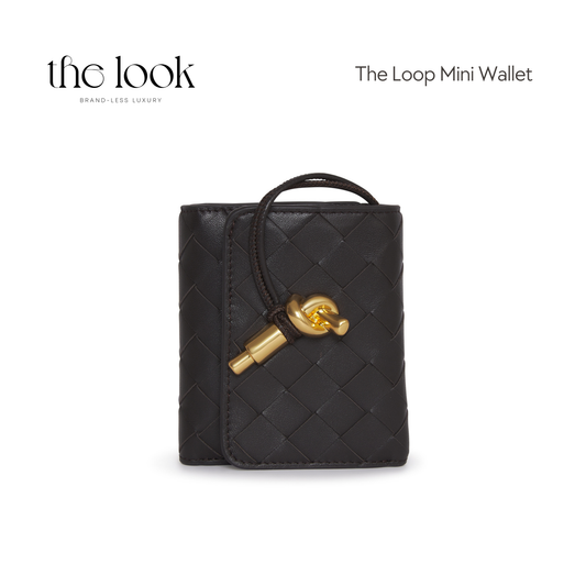 Front view of The Loop Mini Leather Wallet in Fondant black with gold loop charm and woven finish.