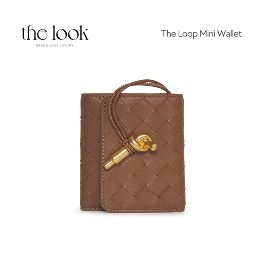 Front view of The Loop Mini Leather Wallet in Praline – features a woven leather texture and signature gold loop clasp.