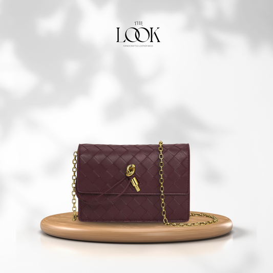 The Loop Wallet on Chain in Burgundy with woven leather exterior and gold-tone chain, front view
