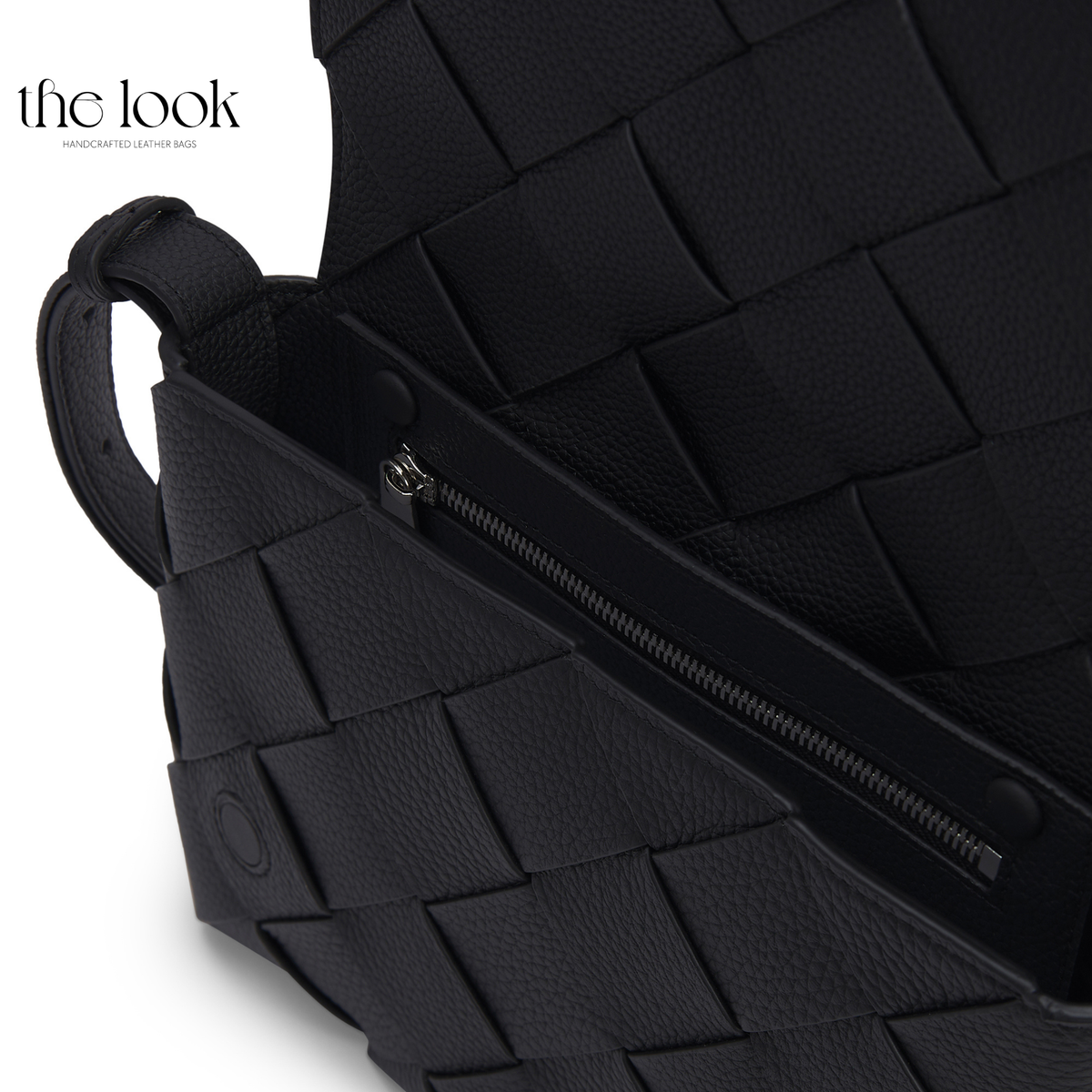Close-up of Loop Weave Crossbody showing textured black leather, woven construction and metal zipper detail | The Look Officiel