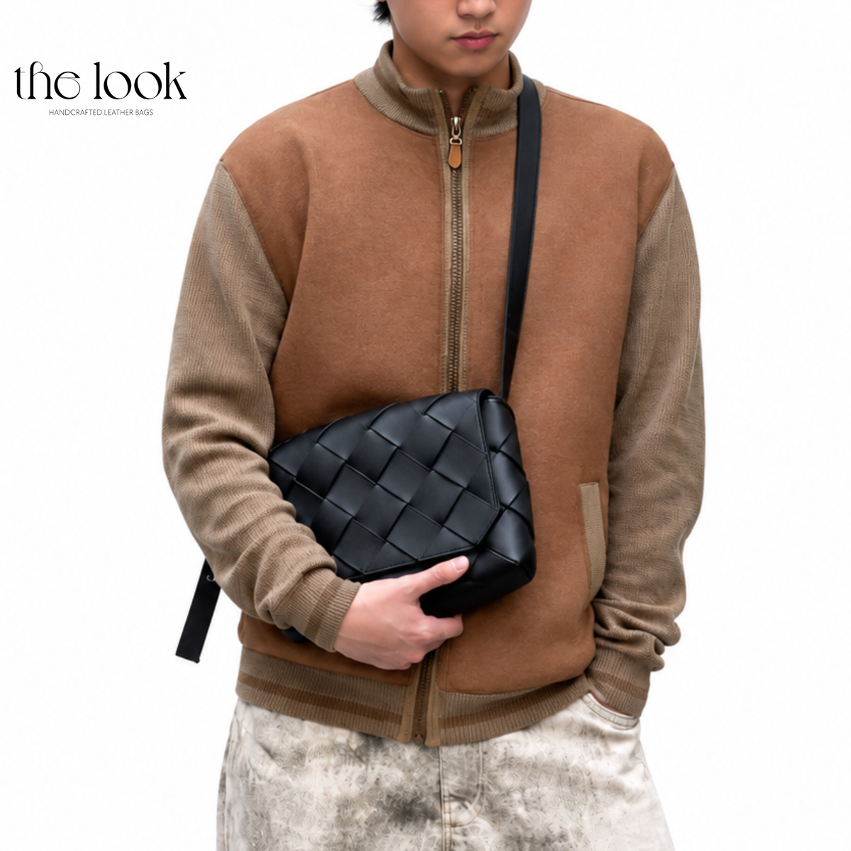 Black Loop Weave Crossbody bag worn across the chest with woven leather flap and adjustable strap | The Look Officiel