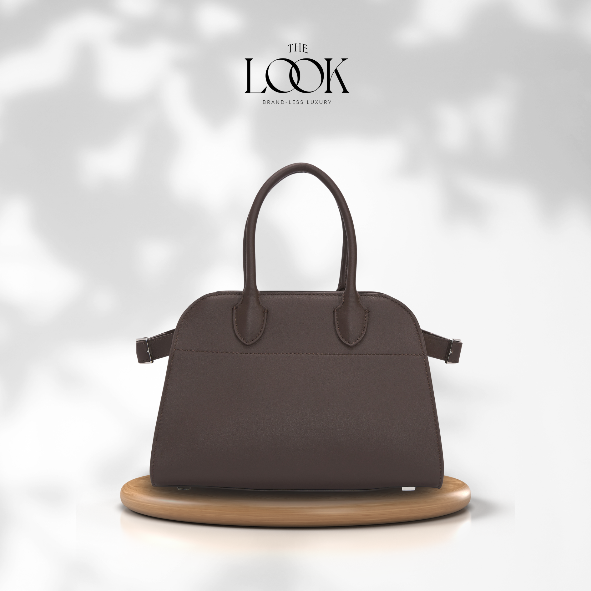 Brown handbag on a wooden stand with 'The Look' brand logo in the corner. | The Look Officiel