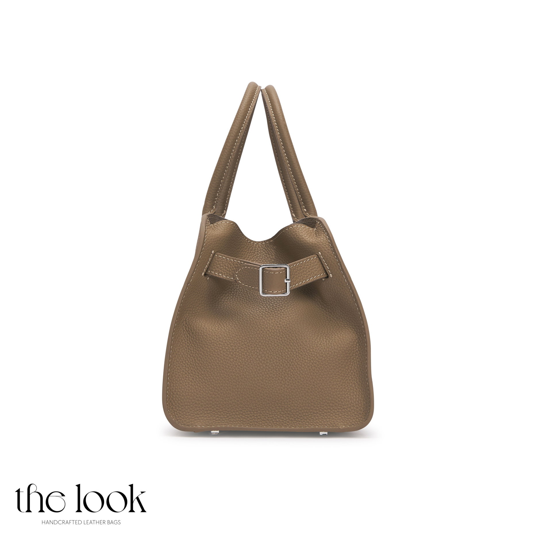 Brown handbag with a silver buckle on a white background, branded 'the look'. | The Look Officiel