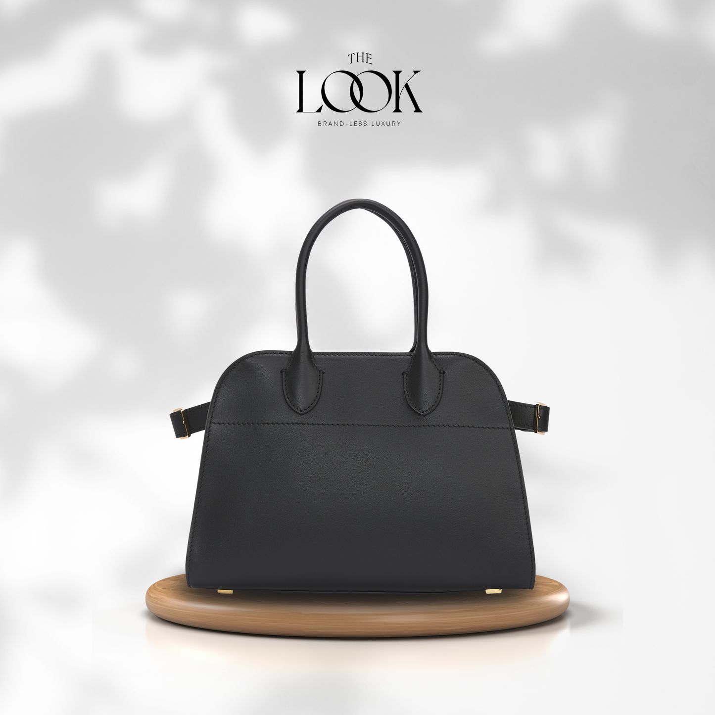 Black handbag on a wooden stand with 'The Look' brand logo in the corner. | The Look Officiel