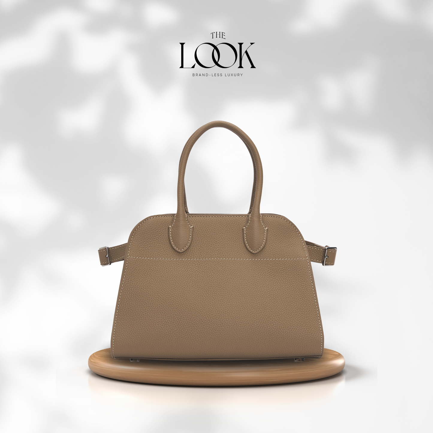 Beige handbag on a white platform with 'The Look' brand logo. | The Look Officiel