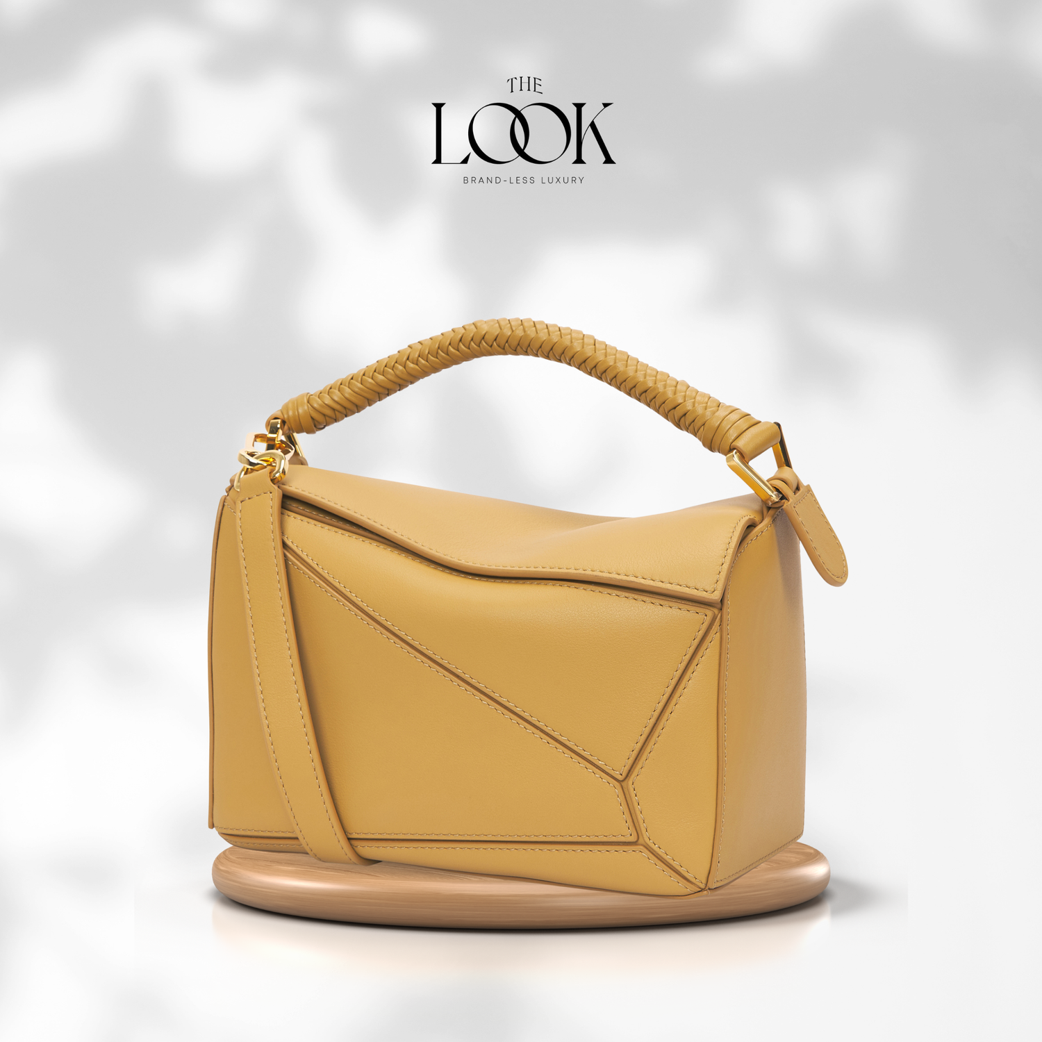 Yellow handbag with braided handle on a white background, featuring 'The Look' brand. | The Look Officiel