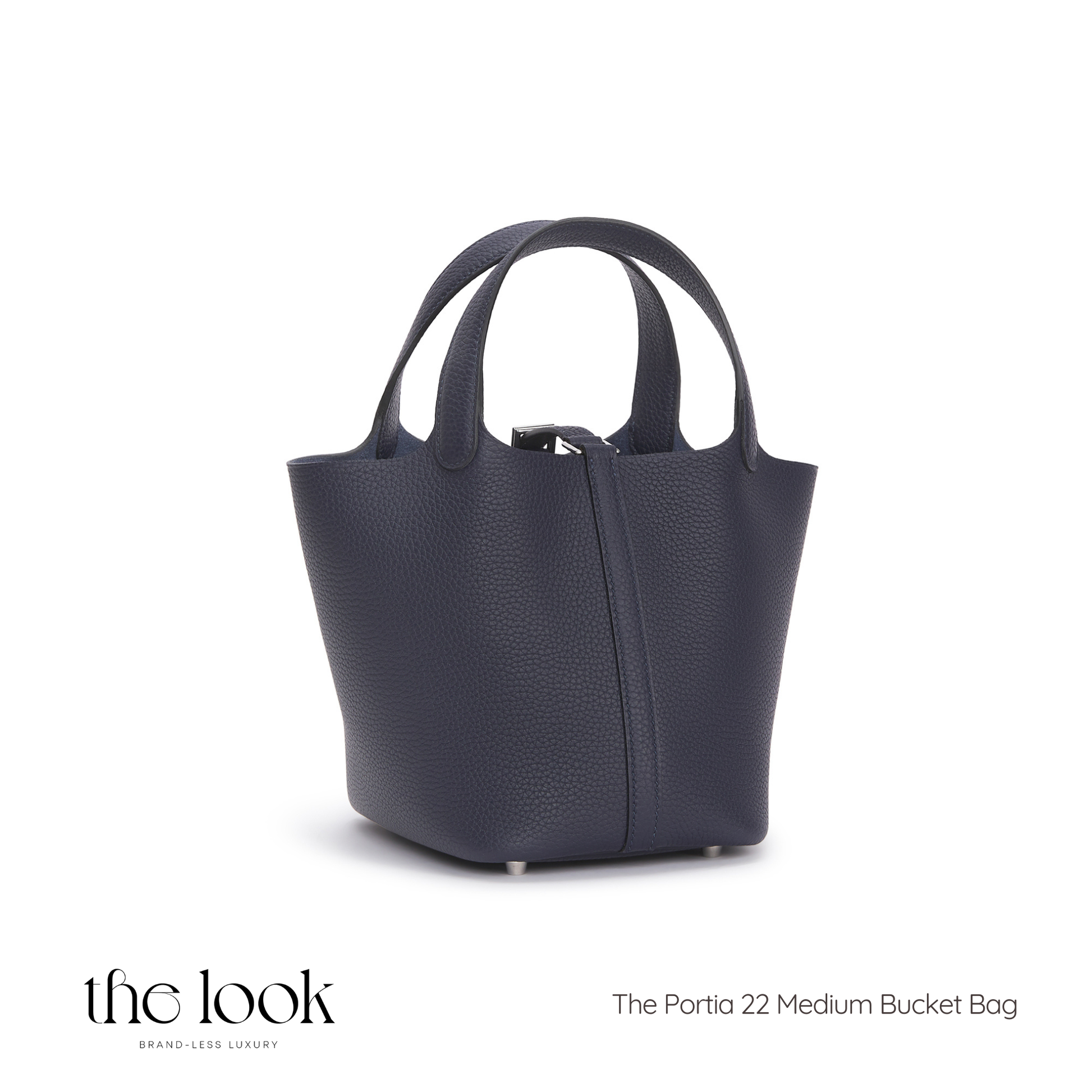 Navy blue handbag labeled 'The Portia 22 Medium Bucket Bag' on a white background | The Look Officiel