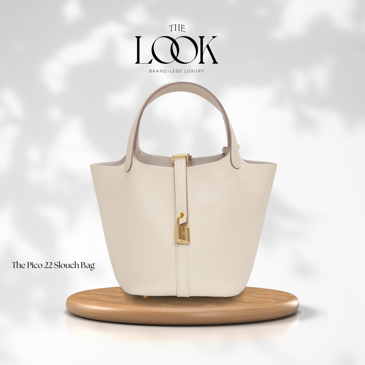 Beige handbag on a wooden stand with 'The Look' branding on a light gray background | The Look Officiel