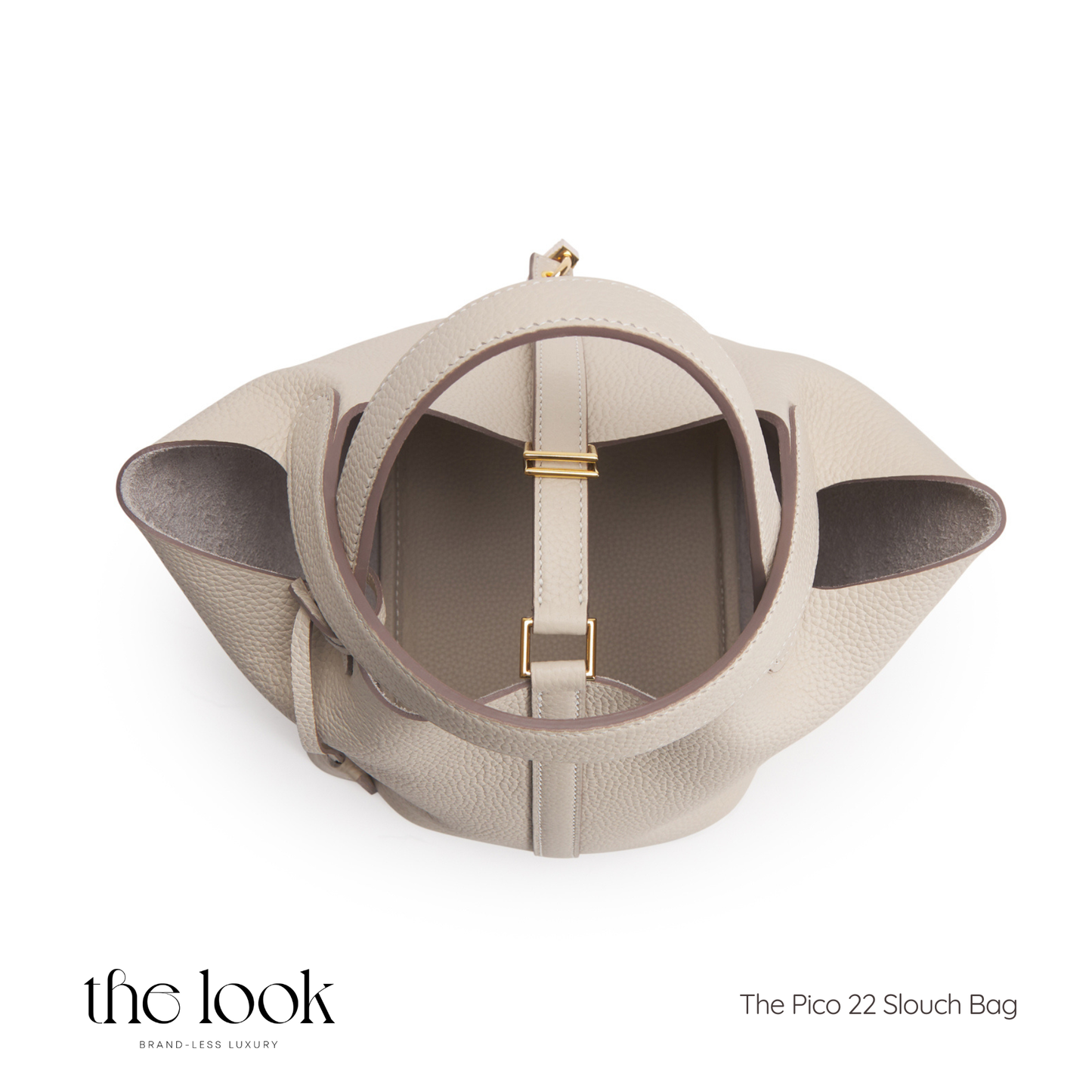 Beige slouch bag with gold accents on a white background, branded 'the look'. | The Look Officiel