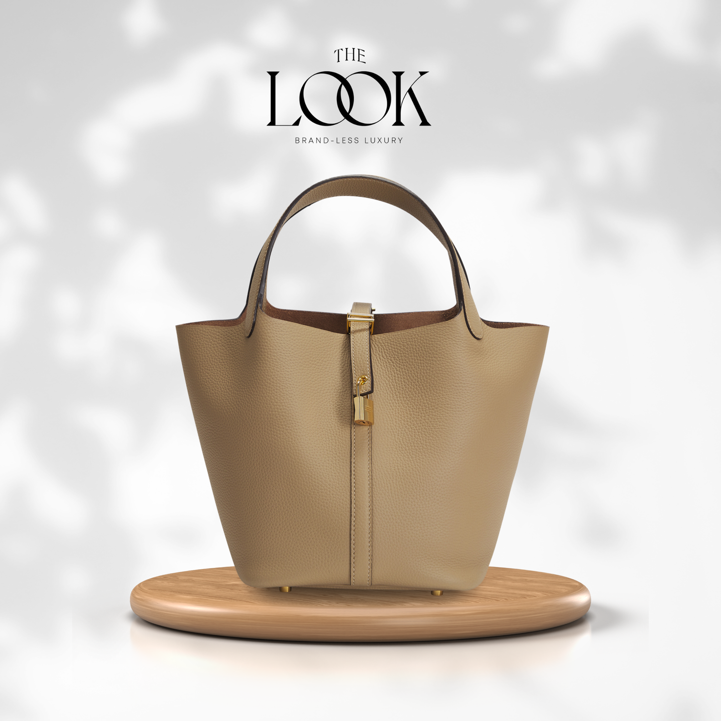Beige handbag on a wooden stand with 'The Look' brand logo in the background | The Look Officiel