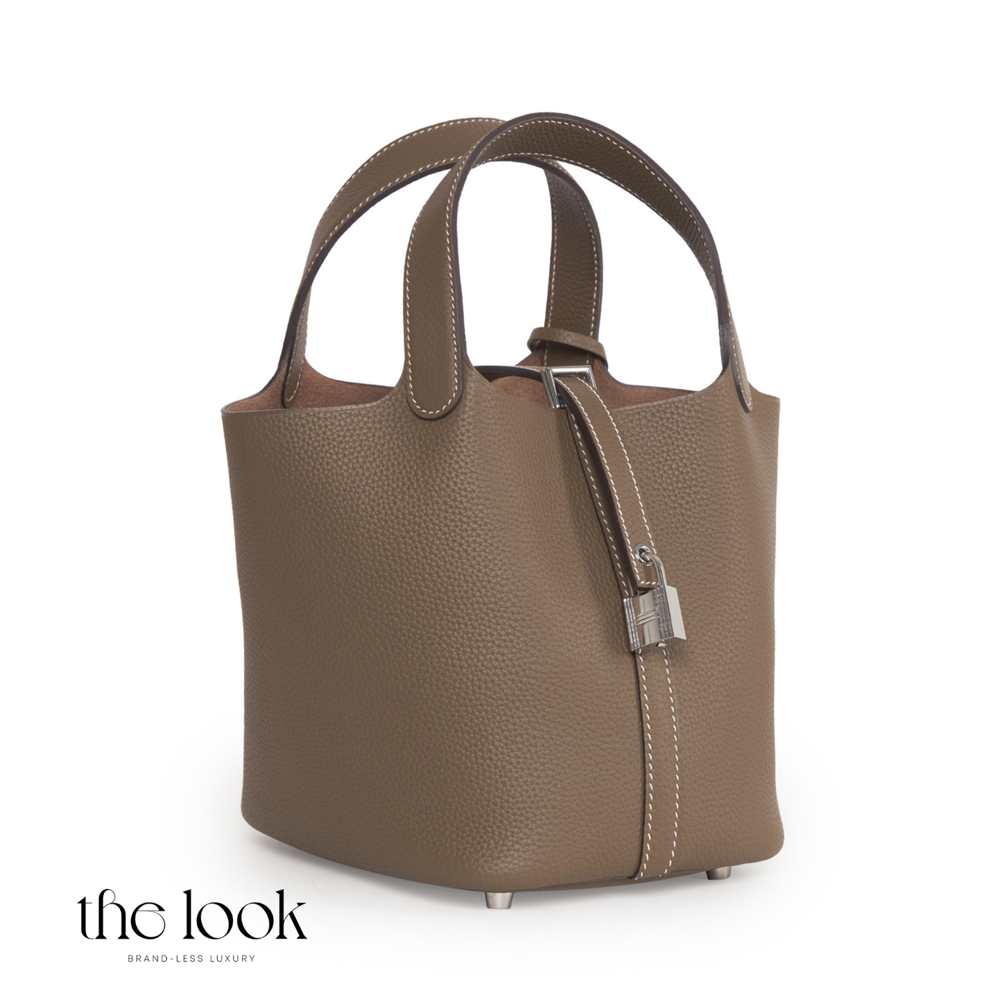 Brown leather handbag with a silver clasp on a white background, featuring 'the look' brand. | The Look Officiel