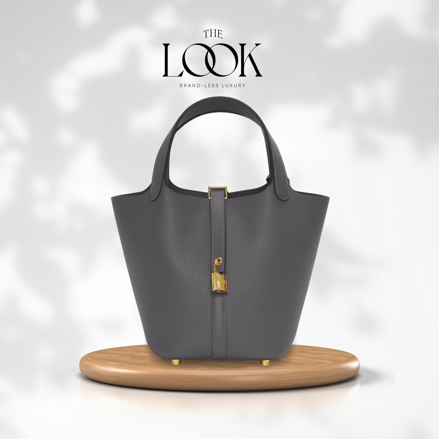 Gray handbag on a wooden stand with 'The Look' branding on a light gray background | The Look Officiel