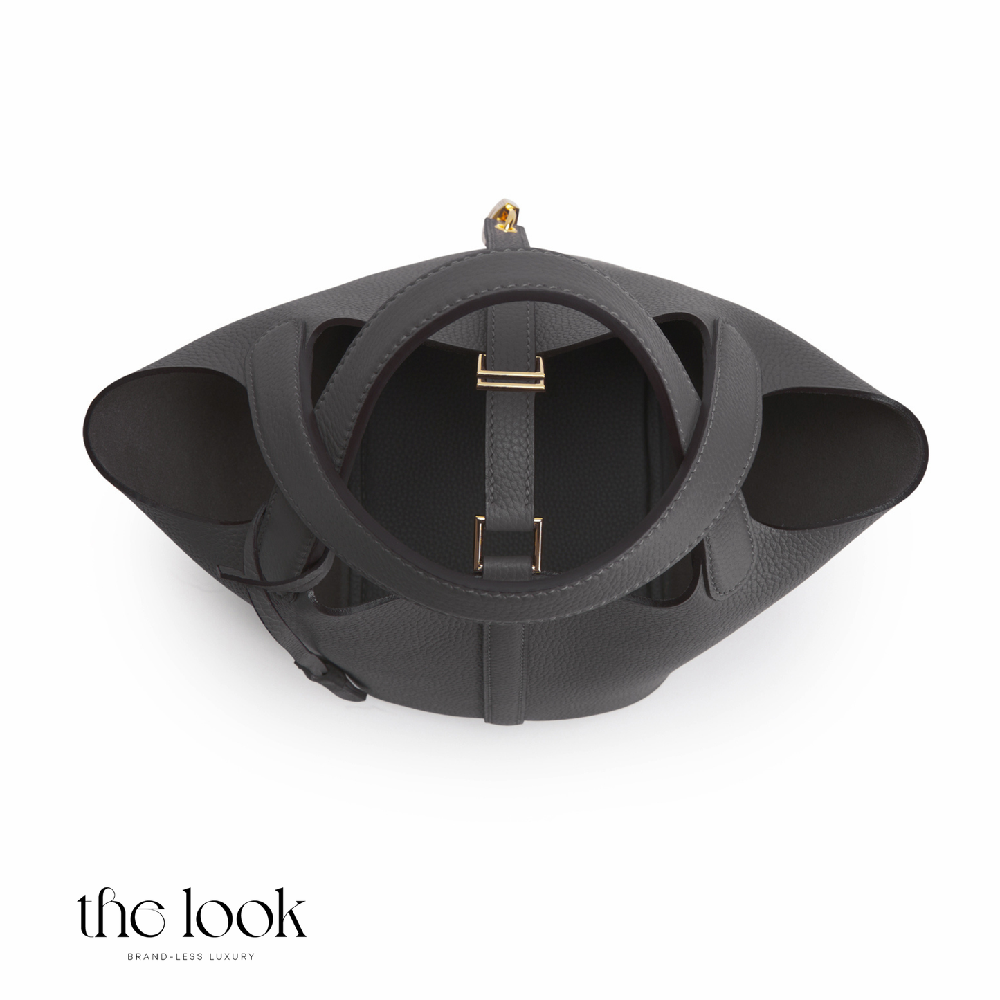 Black leather handbag with gold accents on a white background, featuring 'the look' brand. | The Look Officiel