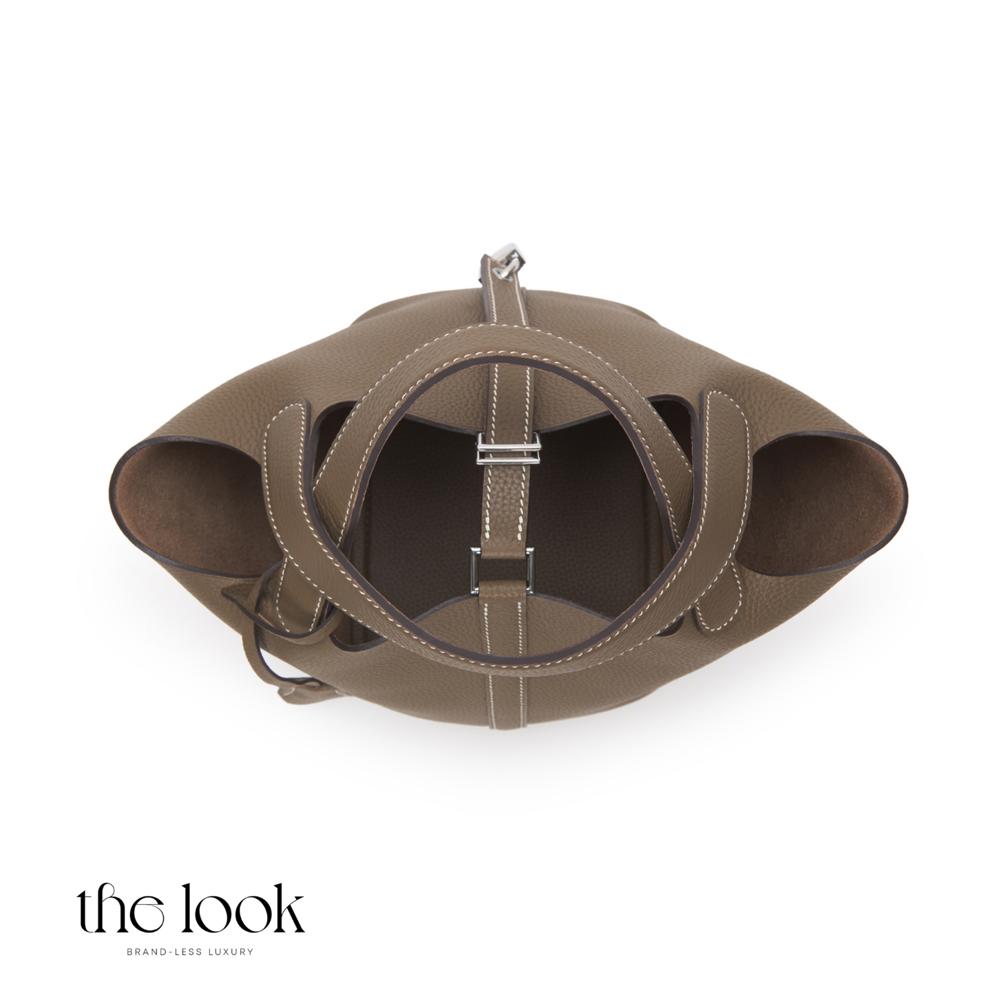 Brown leather handbag with circular design on a white background | The Look Officiel