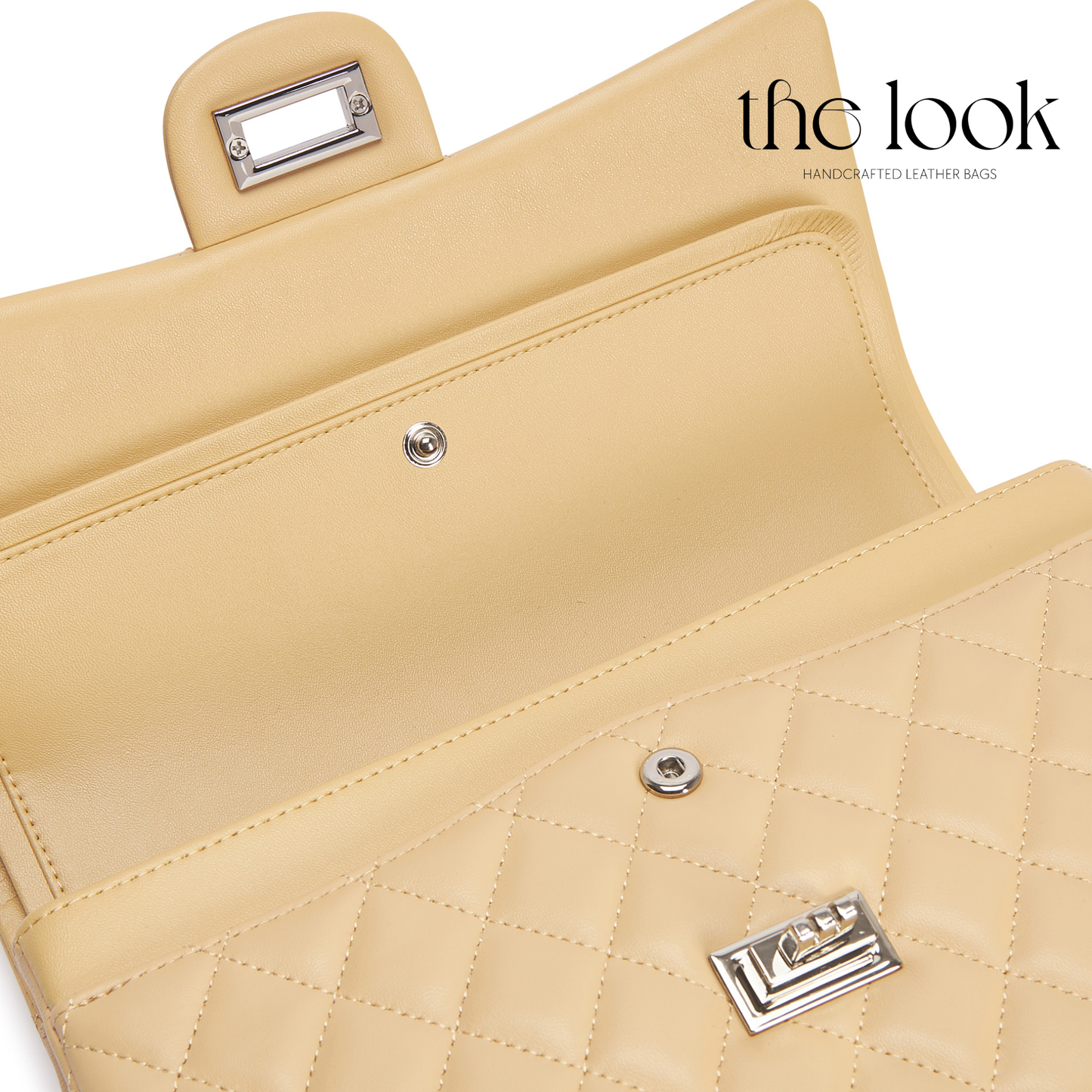 Close-up of a beige handbag with quilted pattern and metal accents, branded 'the look'. | The Look Officiel
