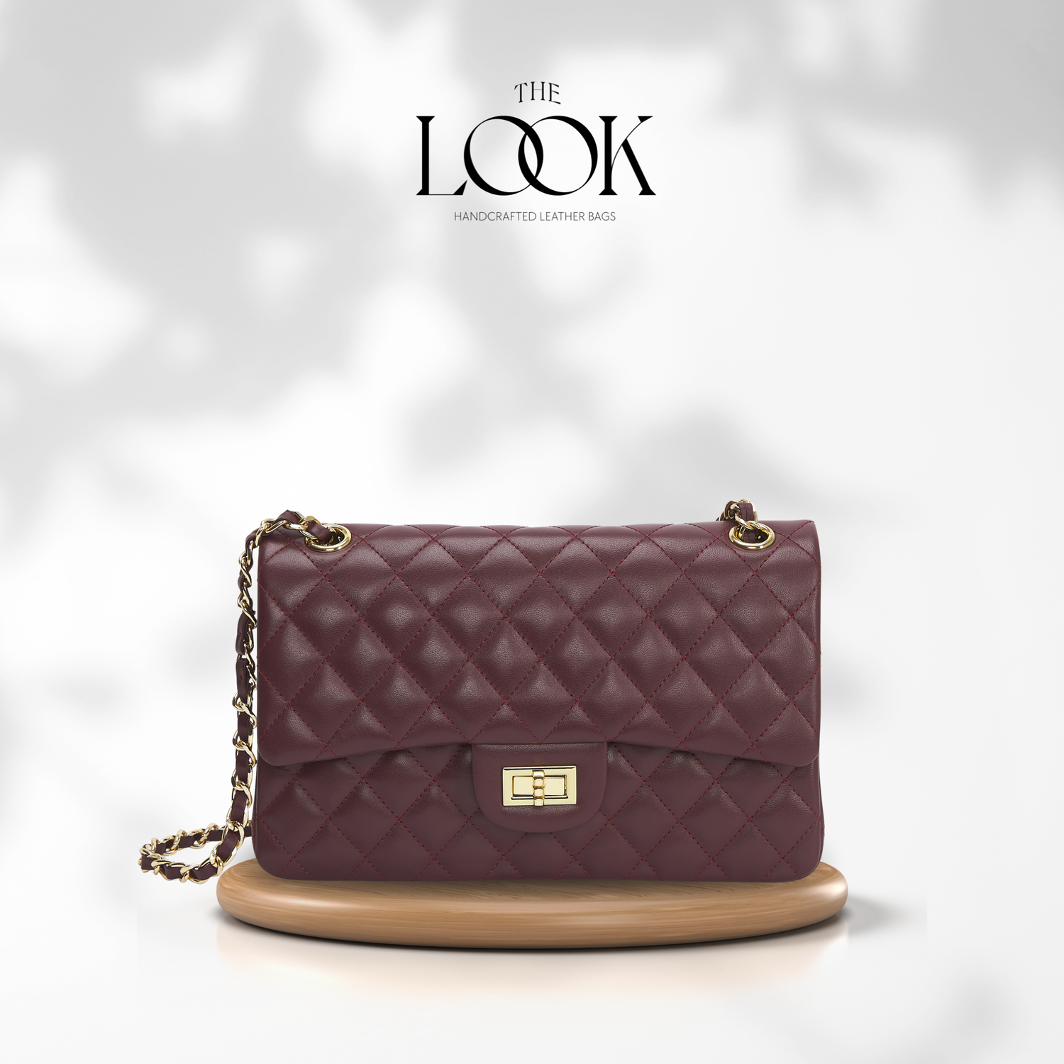 Quilted purple handbag with gold chain on a white background, featuring 'The Look' brand. | The Look Officiel