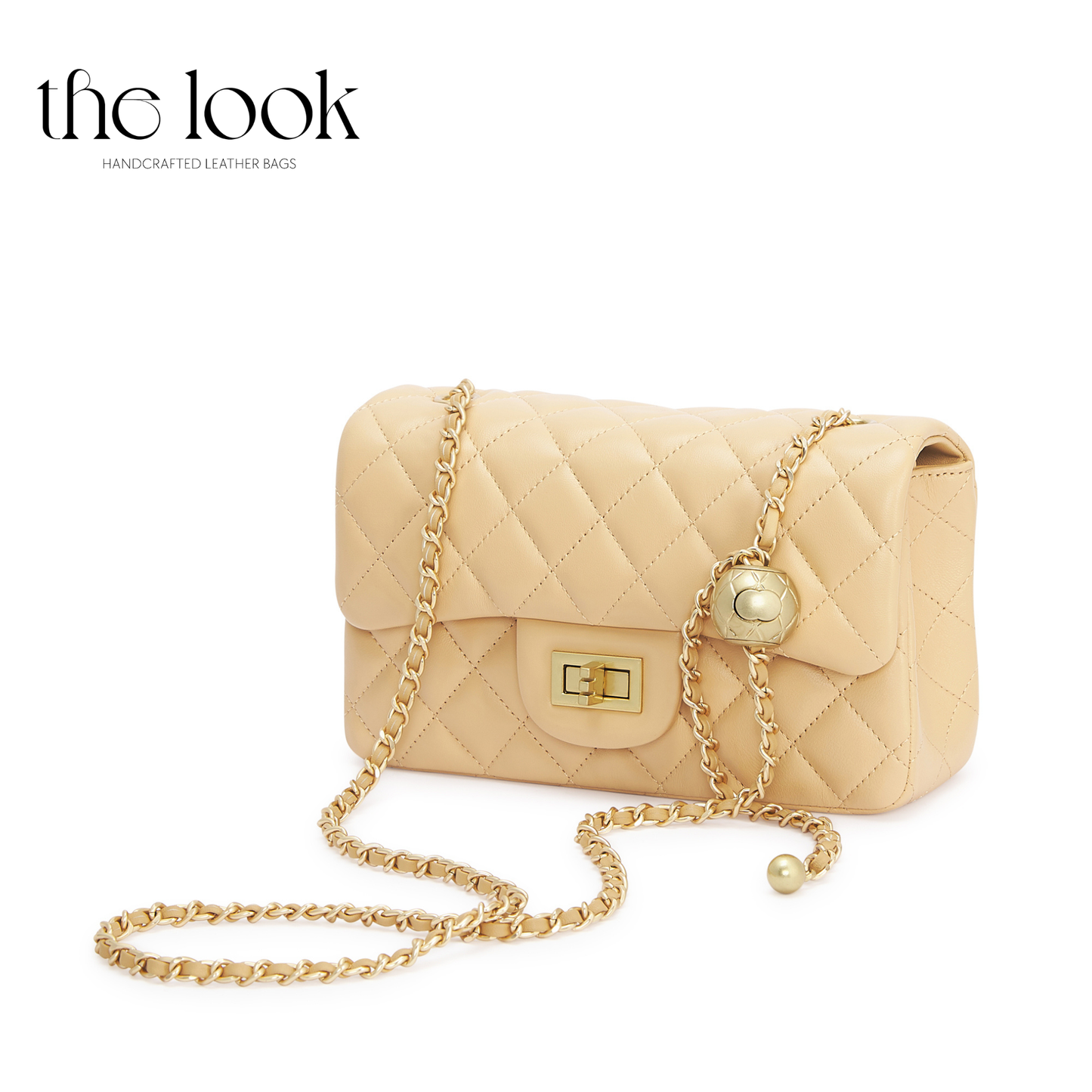 Beige quilted handbag with gold chain strap on a white background, branded 'the look'. | The Look Officiel