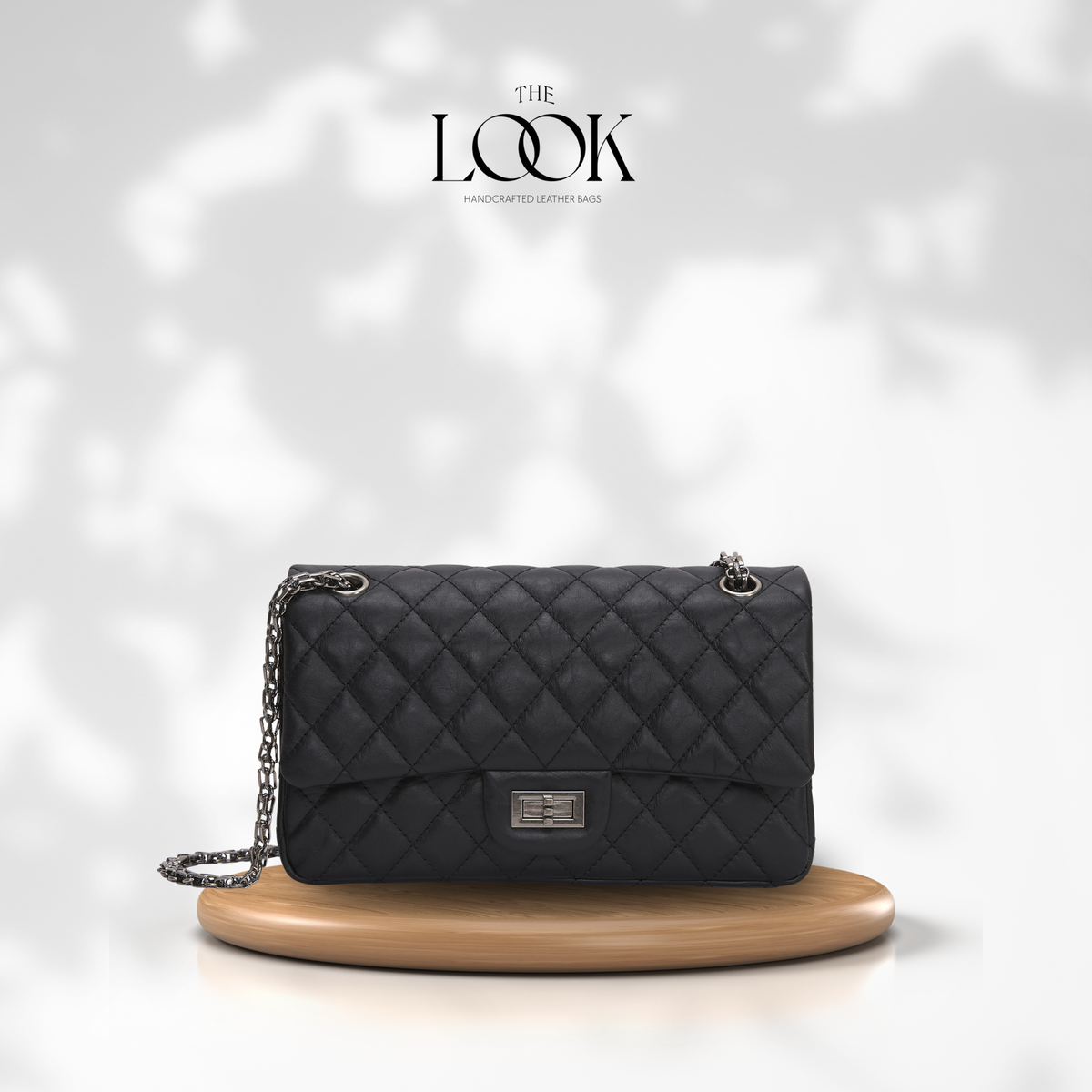 The Quilte Small Distressed Convertible Shoulder Bag in black quilted goatskin leather, front view | The Look Officiel