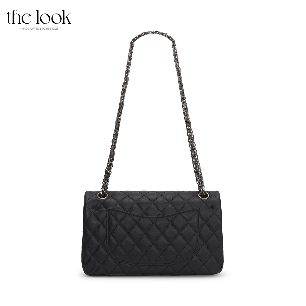 The Quilte Small Distressed Convertible Shoulder Bag in black, rear view with chain strap and exterior slip pocket | The Look Officiel