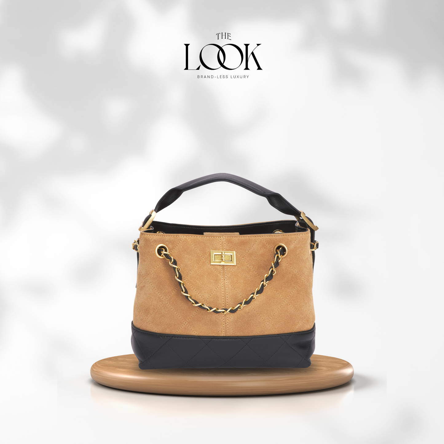 Tan and black handbag with gold chain on a white background, featuring 'The Look' brand. | The Look Officiel