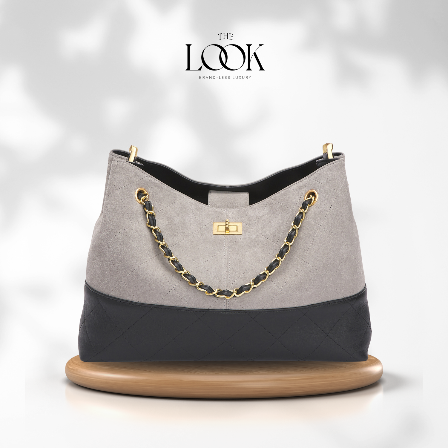 Gray and black handbag with gold chain on a white background, featuring 'The Look' brand. | The Look Officiel