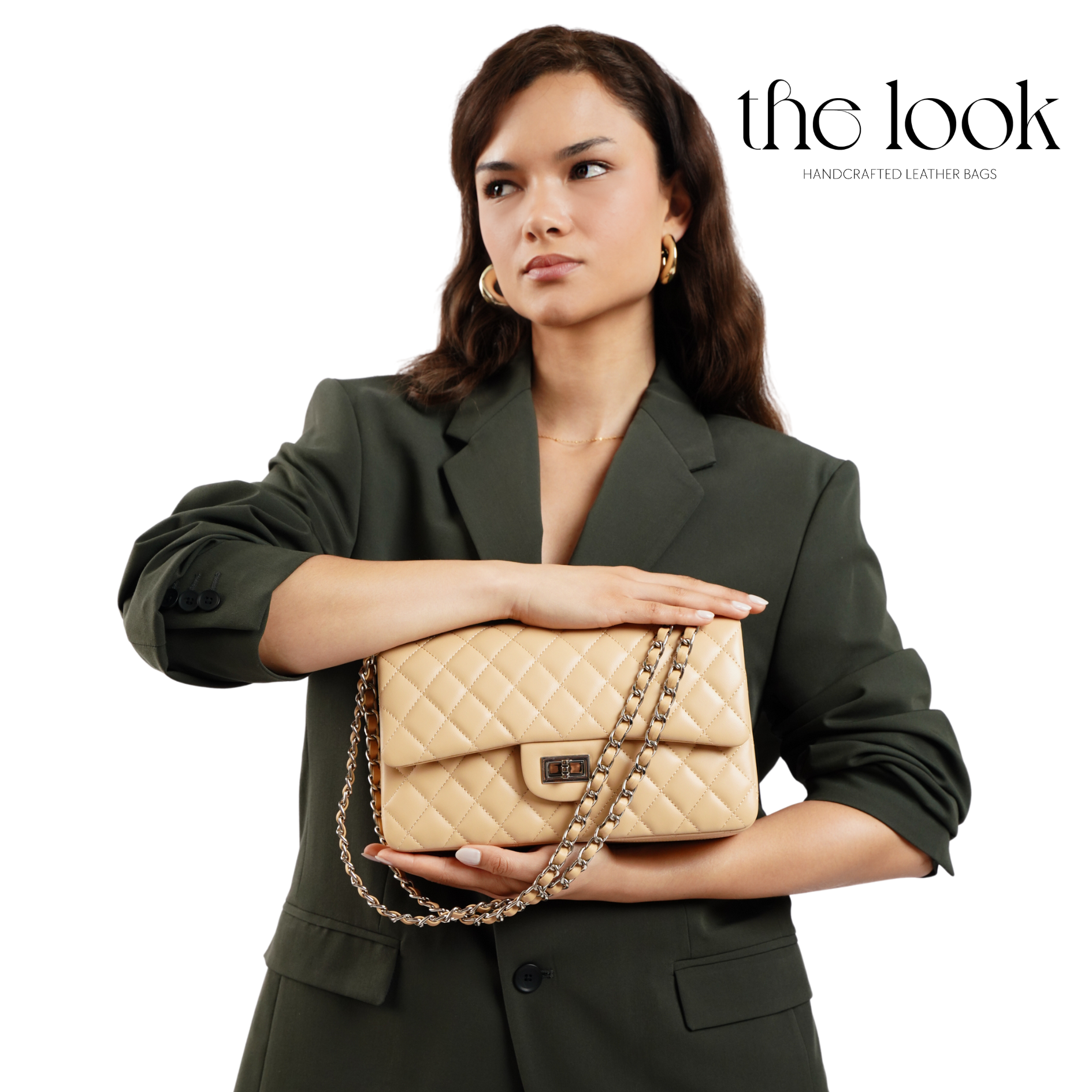 Woman holding a beige quilted handbag with 'the look' branding. | The Look Officiel