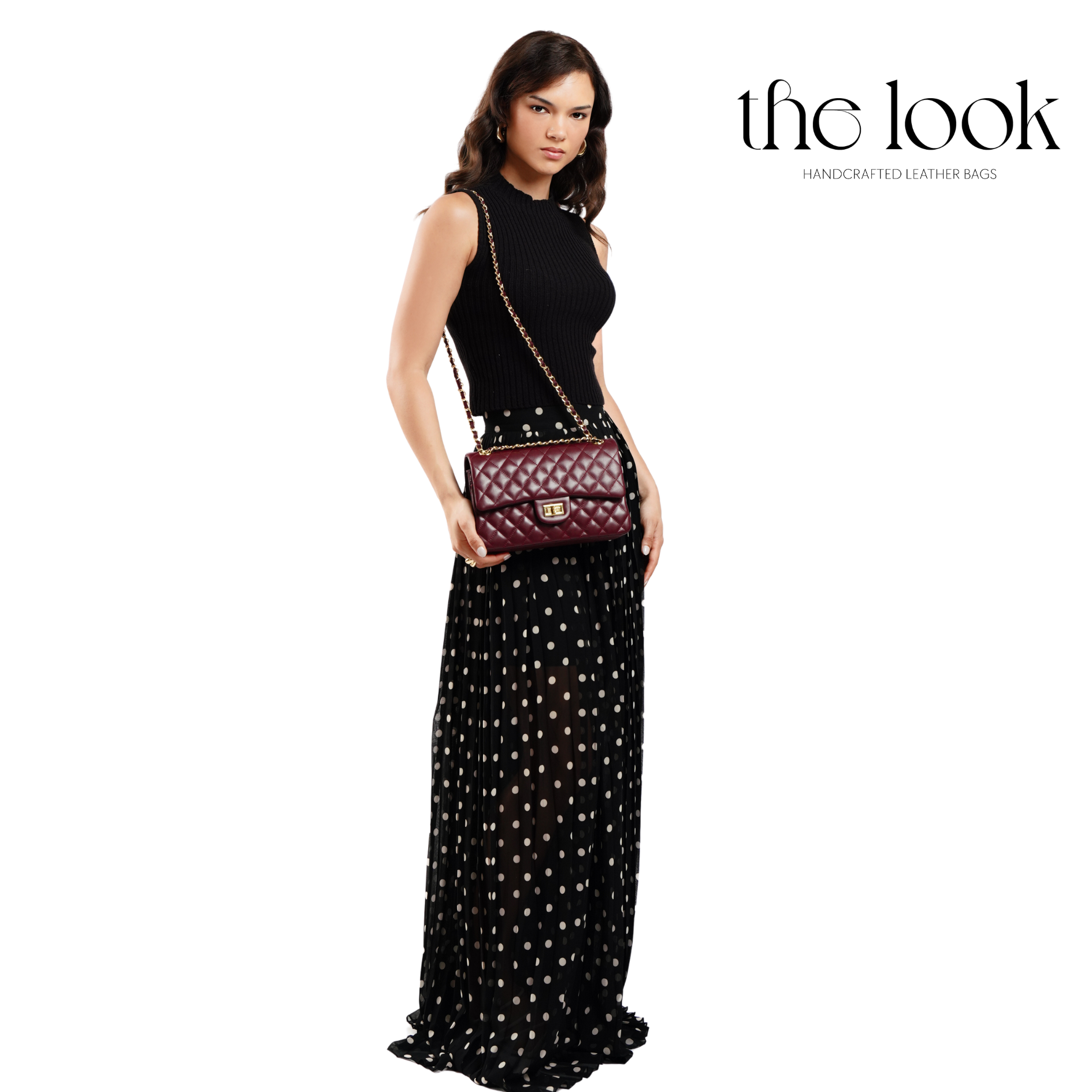 Woman holding a maroon handbag with 'the look' branding on a white background. | The Look Officiel