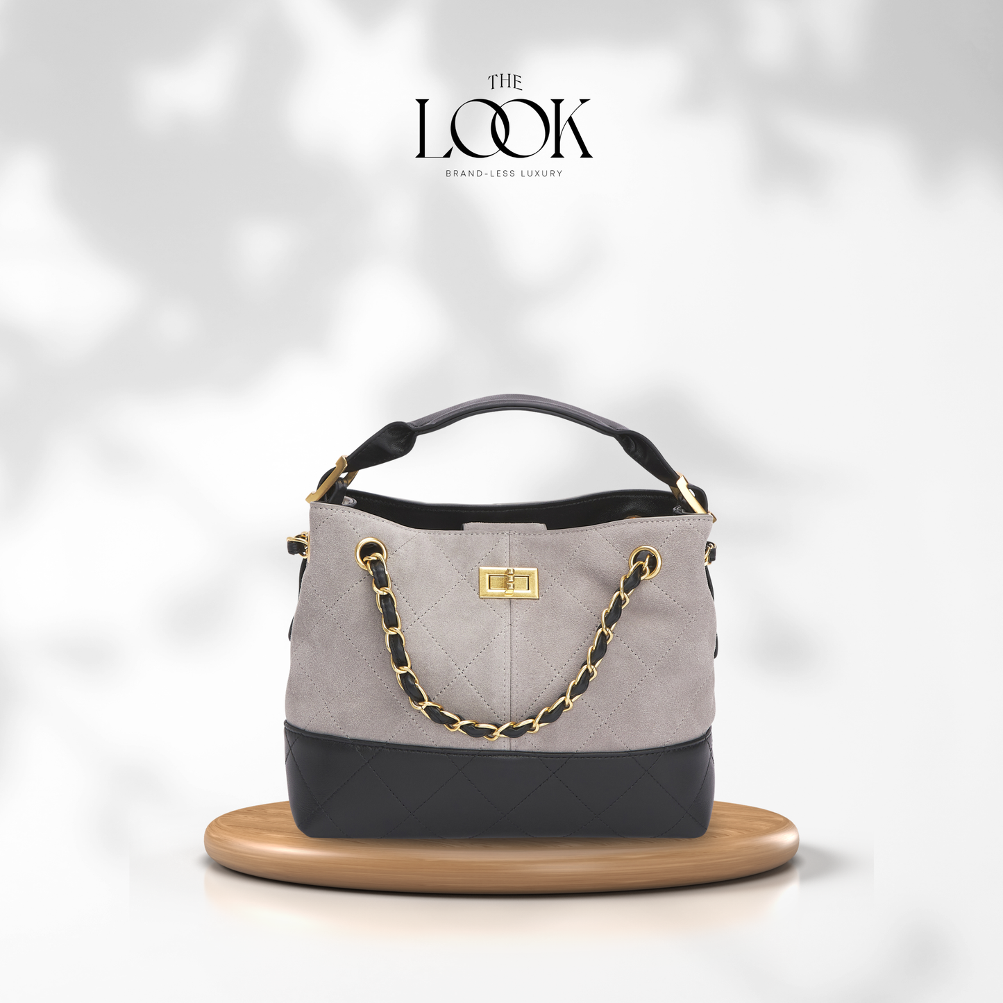 Gray handbag with black accents and gold chain on a white background, featuring 'The Look' brand. | The Look Officiel