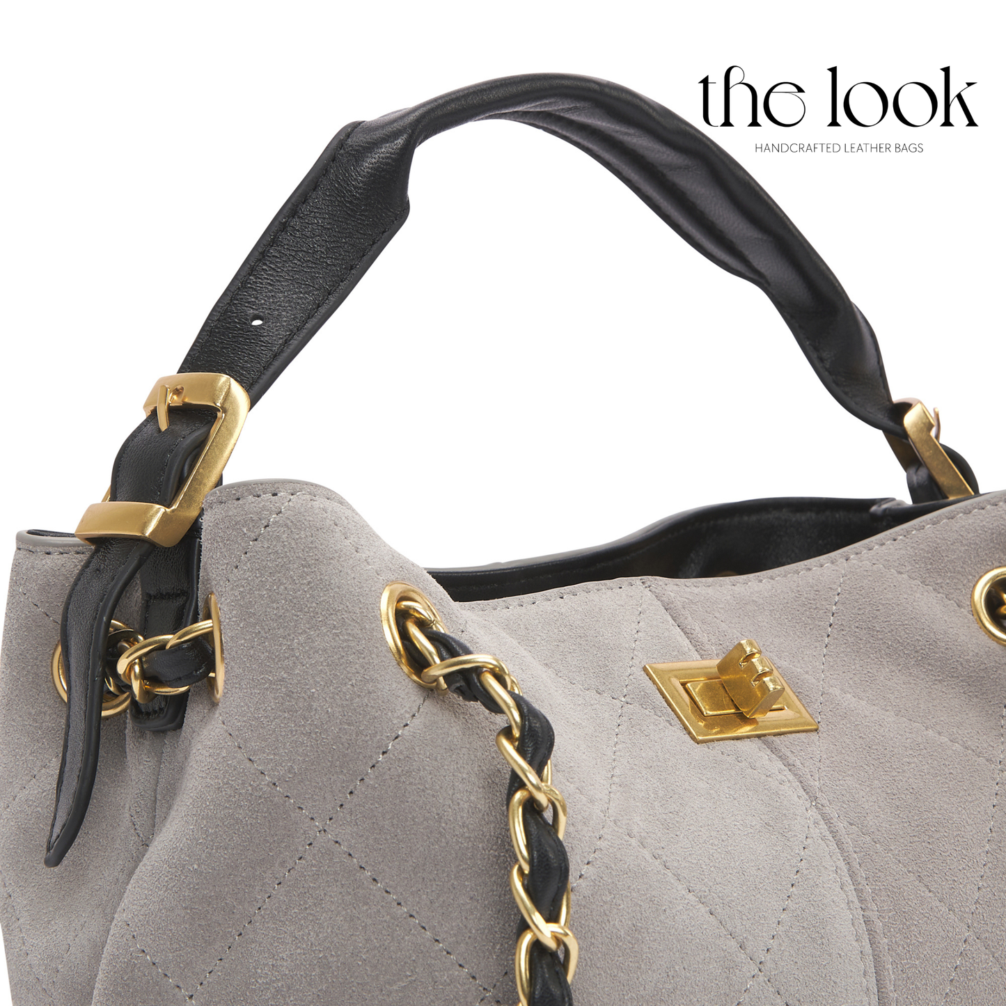Gray handbag with black handle and gold accents on a white background, featuring 'the look' brand. | The Look Officiel