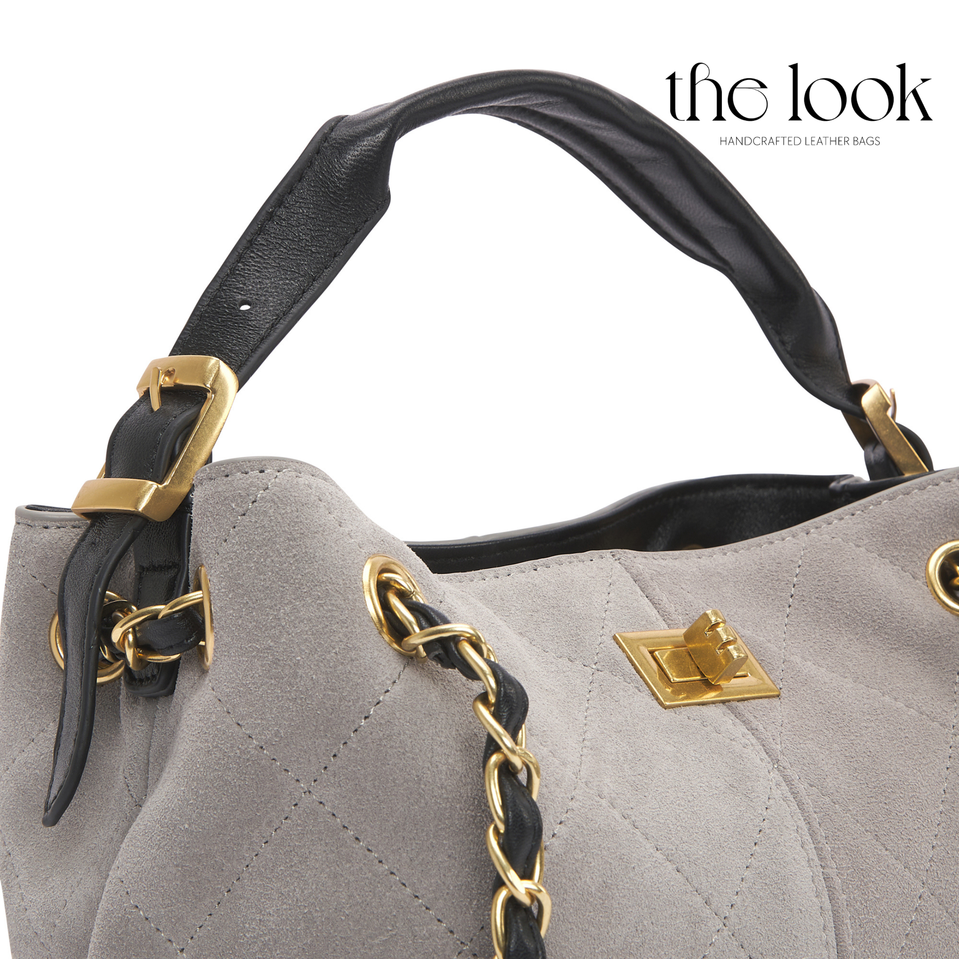 Gray handbag with black handle and gold accents on a white background, featuring 'the look' brand. | The Look Officiel