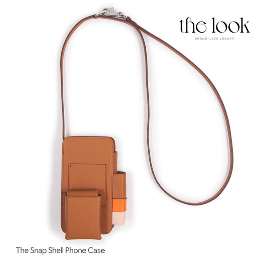 Brown phone case with strap on a white background, featuring 'the look' brand. | The Look Officiel