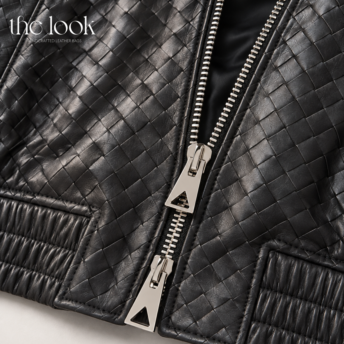 Close-up of The Loop Weave Bomber Jacket in Black, showing woven leather and stainless steel zipper