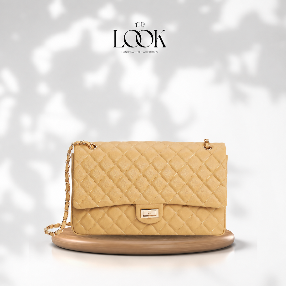 The Quilte Extra Large Convertible Shoulder Bag in Biscuit with champagne gold hardware, front view | The Look Officiel