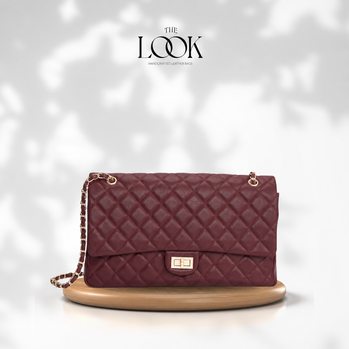 The Quilte Extra Large Convertible Shoulder Bag in Burgundy with champagne gold hardware, front view | The Look Officiel