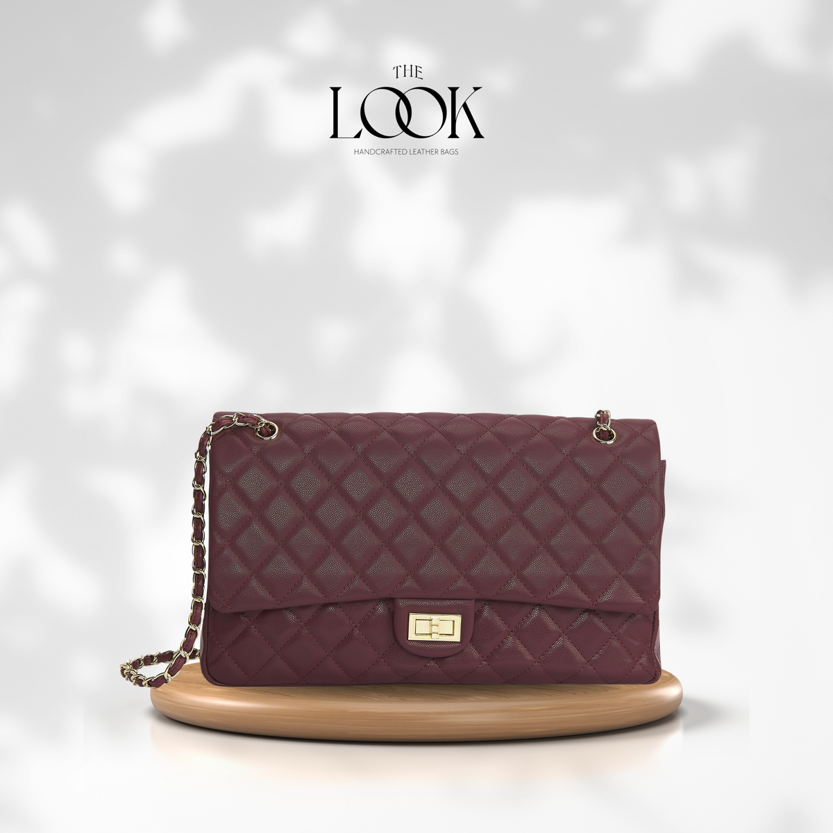 The Quilte Extra Large Convertible Shoulder Bag in Burgundy with silver hardware, front view | The Look Officiel