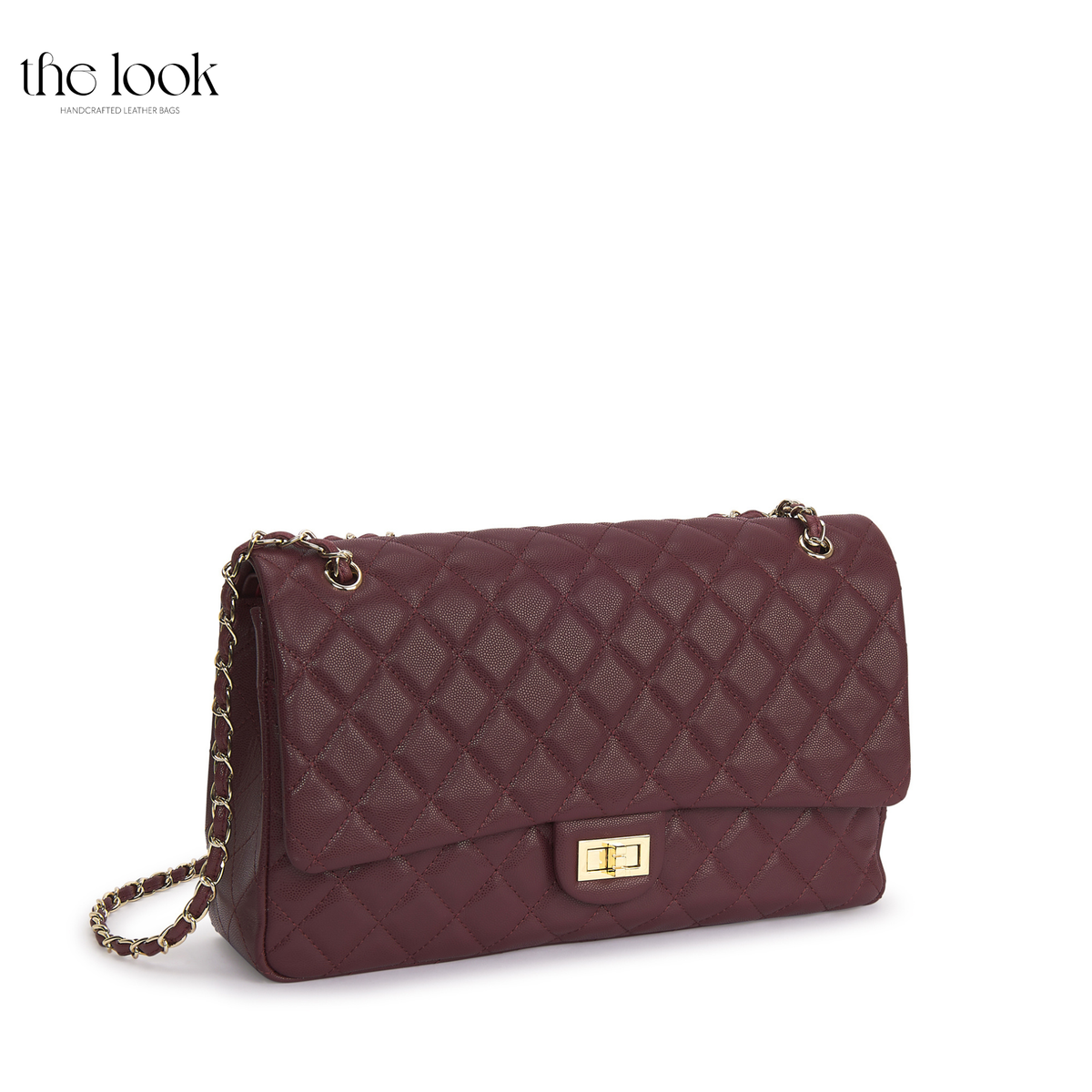 The Quilte Extra Large Convertible Shoulder Bag in Burgundy with champagne gold hardware, three-quarter view | The Look Officiel