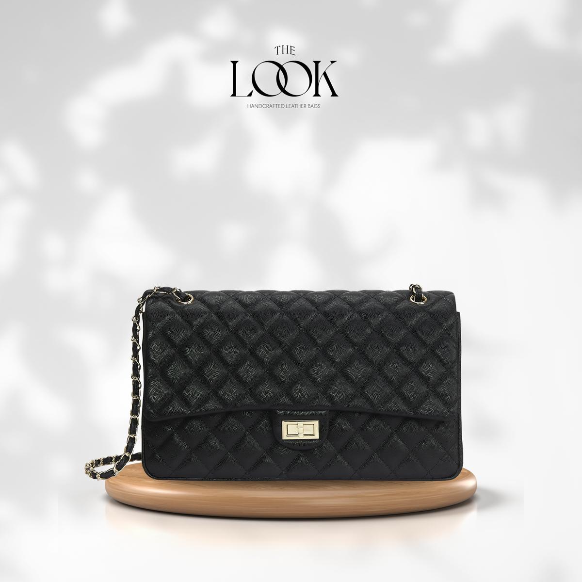The Quilte Extra Large Convertible Shoulder Bag in Black with silver hardware, front view | The Look Officiel