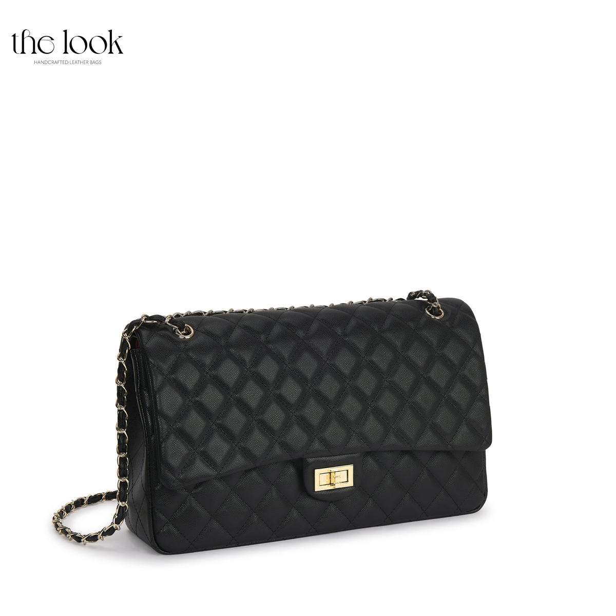 The Quilte Extra Large Convertible Shoulder Bag in Black with champagne gold hardware, three-quarter view | The Look Officiel