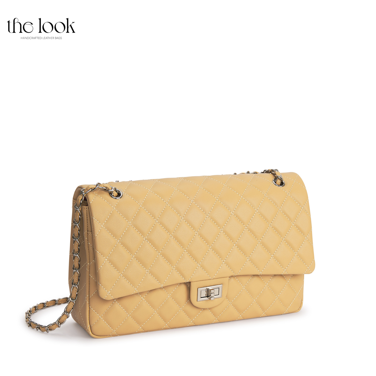 The Quilte Extra Large Convertible Shoulder Bag in Biscuit with silver hardware, three-quarter view | The Look Officiel