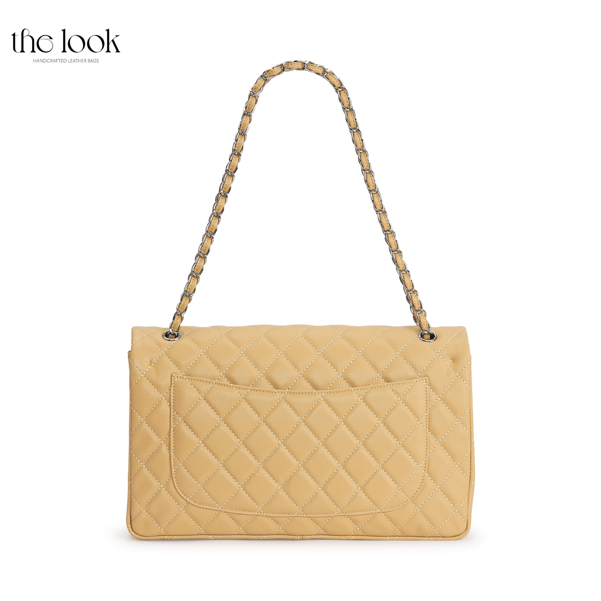 The Quilte Extra Large Convertible Shoulder Bag in Biscuit with chain strap extended, back view | The Look Officiel