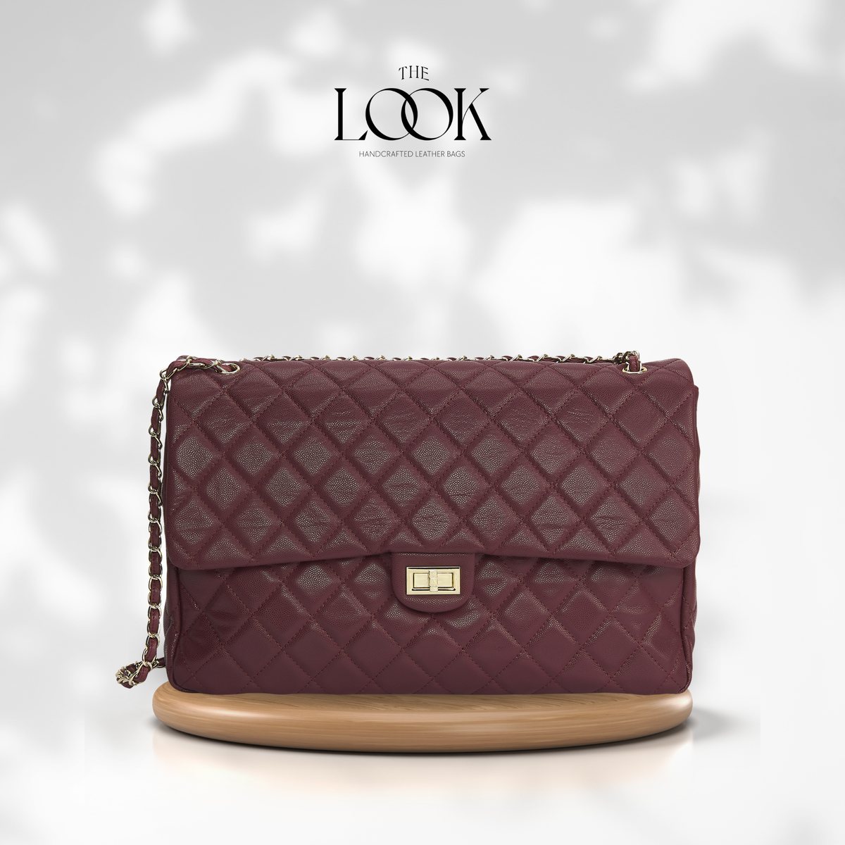 Burgundy The Quilte Jumbo Convertible Travel Bag with silver hardware, front view | The Look Officiel