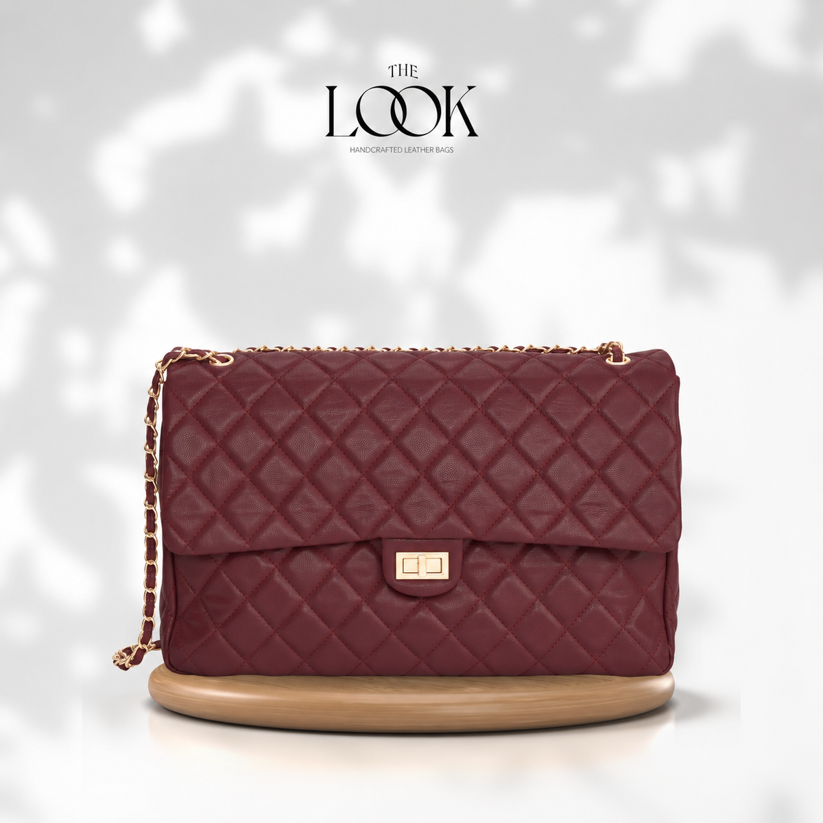 Burgundy The Quilte Jumbo Convertible Travel Bag with champagne gold hardware, front view | The Look Officiel