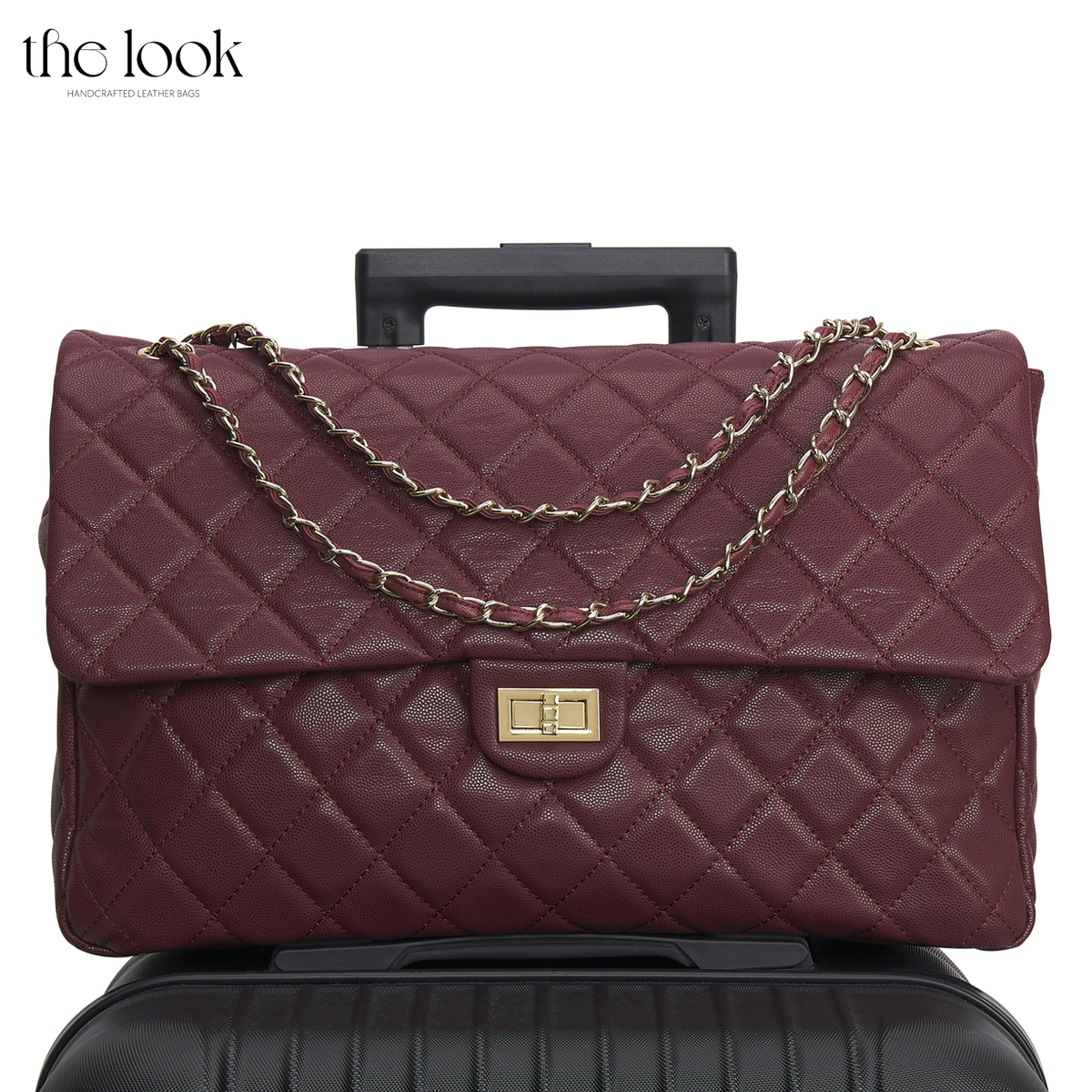 The Quilte Jumbo Convertible Travel Bag in Burgundy caviar calfskin leather on a suitcase with chain strap | The Look Officiel
